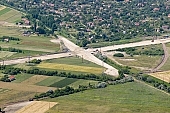 highway, aerial, road, E5, E75, Szeged, Budapest, air photograph, air photo, Kecskemet, Kiskunfelegyhaza, Hungary, transportation, traffic, horticulture, barrier, bar, fence, birds eye view, banister, delimination, bridge, holiday home, holiday resort, house, houses, overpass, perspective, nature, bridges, power-line, wire, fruit tree, plantation, electric line, car, cars, lane, lanes, painted lane, speed, range of speeds, fast, fast transportation, menacing, cloud, clouds, sky, cut, dike, ditch, pit, trench, water-jump, asphalt, bitumen, blacktop, concrete, standing, arc of a circle, arc, holidaymakers, Kiss Lszl, Lszl Kiss